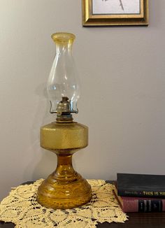 an old fashioned oil lamp sitting on top of a table