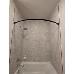 a bathtub and shower in a bathroom with white tile on the floor, walls and ceiling