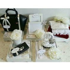 white flowers are sitting in small boxes on the floor next to purses and other items