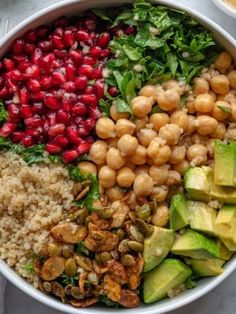 a white bowl filled with different types of vegetables and grains on top of a table