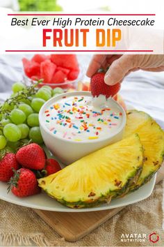 a person dipping fruit into a bowl with sprinkles and strawberries on the side