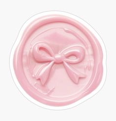 a pink wax stamp with a bow on it