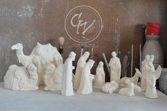 a group of white figurines sitting on top of a table next to each other