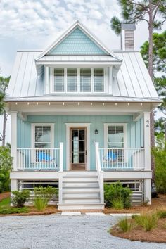 a small blue and white house with porches