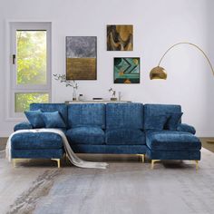 a living room with blue couches and pictures on the wall above it, along with a rug