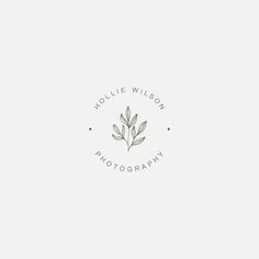 a logo for a photographer with leaves on the top and bottom, as well as an oval