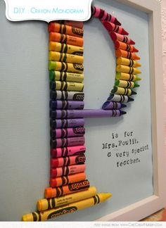 the letter d made out of crayons is displayed in a white framed frame