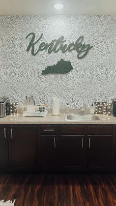 a kitchen area with two sinks, coffee maker and other items on the counter top