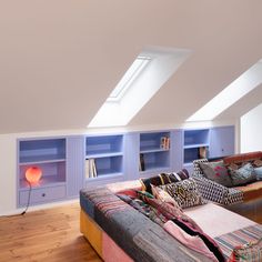 a living room filled with lots of furniture and bookshelves on top of it