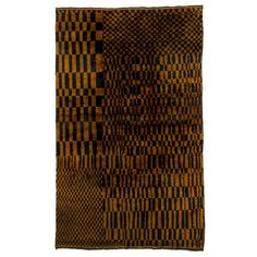 a brown and black rug with squares on it