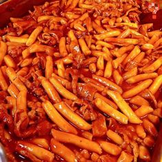 a large pan filled with pasta covered in sauce