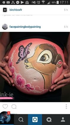 a pregnant woman holding her belly painted with the disney character lady and the tramp