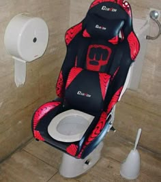 the seat on the toilet is decorated with red and black designs