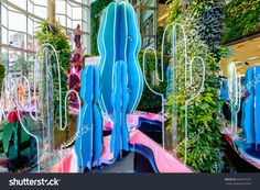 the interior of an indoor shopping mall with blue and pink decorations on display stock photo