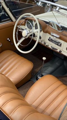 the interior of an old car with brown leather seats