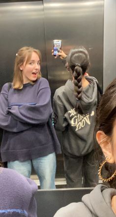 a woman taking a selfie in an elevator