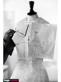 a dress being made on a mannequin in black and white with an image of a woman's dress