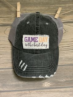 "It's GAME DAY! Sport your favorite hat while supporting your favorite team! This hat is perfect to throw your hair up in this criss cross ponytail hat! Unisex distressed gray trucker hat with gray adjustable(velcro) mesh backing. Patch is handmade and says \"Game Day is the best day\" in black, purple and gold. Can put any patch from our shop on this hat! Put in notes to seller." Criss Cross Ponytail, Gold Hat, Gold Hats, Ponytail Hat, The Best Day, Vinyl Projects, Up Hairstyles, Trucker Cap, Favorite Team