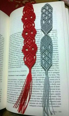 an open book with two crocheted tassels on top of each other