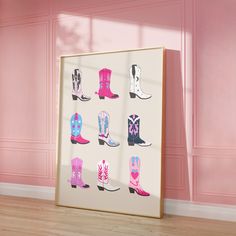 a framed photo with cowboy boots on it in front of pink walls and wooden floors