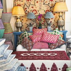 a room filled with lots of colorful pillows and lamps on top of eachother