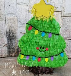 a green christmas tree made out of pieces of paper