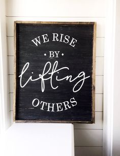 a sign that says we rise by lifting others