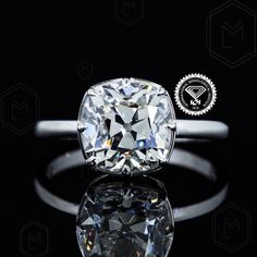 a cushion cut diamond sits on top of a black surface with the words,'diamonds are