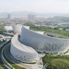 an aerial view of the exterior of a building with curved walls and circular walkways