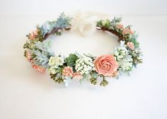 a flower crown made out of flowers and greenery