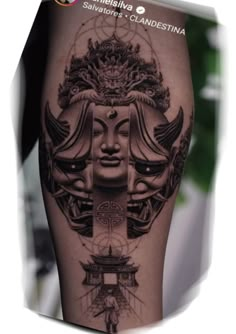 a woman's leg with tattoos on it and an image of a face in the middle