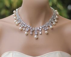 "If you love Hollywood glamour, here's the wedding jewelry you've been searching for. The sparkling, crystal and pearl design of the 'Juliette' necklace features marquise and round shaped crystals in an eye-catching statement style. With Swarovski pearls dotted throughout the necklace, it will take your breath away. ❣ If you would prefer an all crystal necklace please select from pearl color menu. ❣ Available in rose gold, silver (rhodium) and gold. ❣ Necklace measures 17\" ❣ Nickel-free and non Pearl White Crystal Bridal Necklace For Wedding, Bridal Necklace With Pearl Drop For Wedding, Crystal Bridal Necklace With Pearl Drop For Anniversary, Crystal Pearl Drop Necklace For Wedding, Anniversary Crystal Bridal Necklace With Pearl Drop, Pearl White Crystal Bridal Necklace For Anniversary, Statement Wedding Jewelry, Crystal Wedding Necklace, Bridal Pearl Necklace