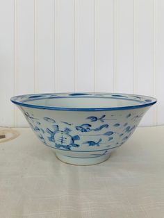 a blue and white bowl sitting on top of a table