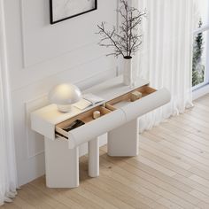 a white table with two drawers and a vase on it in front of a window