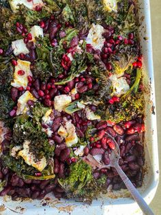 a casserole dish with broccoli, cauliflower and red beans