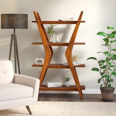 a living room with a white chair and wooden shelving unit next to a potted plant