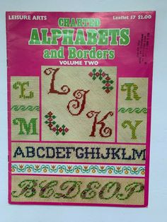 the front cover of an alphabet and letters cross stitch pattern book, with numbers on it