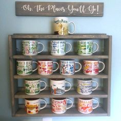 there are many coffee cups on the shelf