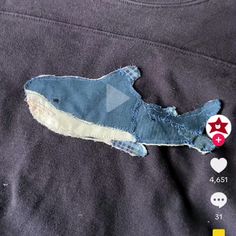 a piece of cloth with some sort of animal on it's side and the other part torn off