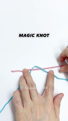 two hands are holding yarn over a piece of paper with the word magic knot written on it