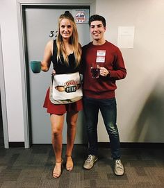 a man and woman standing next to each other in front of a door holding coffee mugs