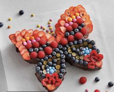 two pieces of cake decorated with berries and candy