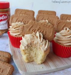 cupcakes with peanut butter frosting and cookies on a plate next to them