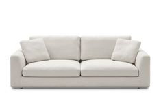 a white couch with two pillows on it