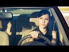 a woman sitting in the drivers seat of a car