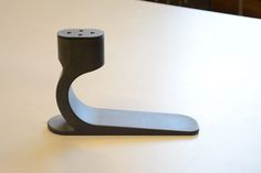 a black object sitting on top of a white table