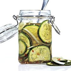 pickled cucumbers in a jar with a spoon