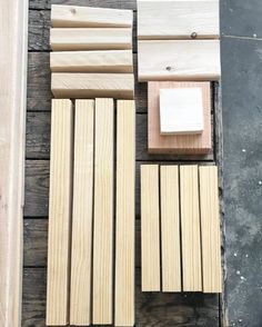 several pieces of wood sitting on top of a wooden floor next to a piece of plywood