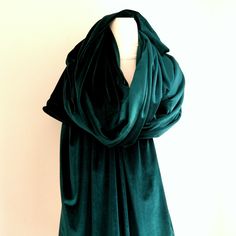 a green scarf draped over a mannequin's head