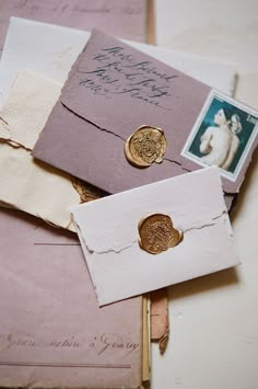 an envelope with two waxed stamps and some other items